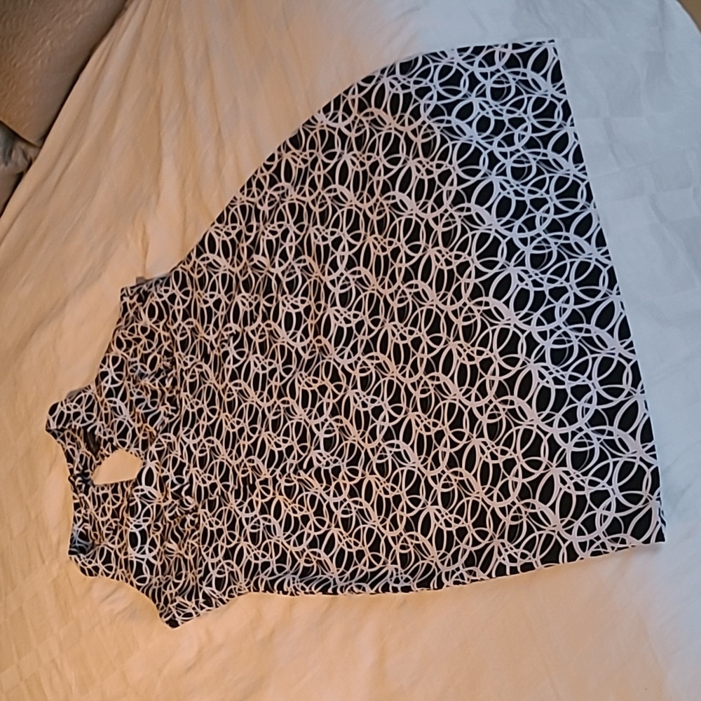 Shoulder-baring black and white, knee-length dress